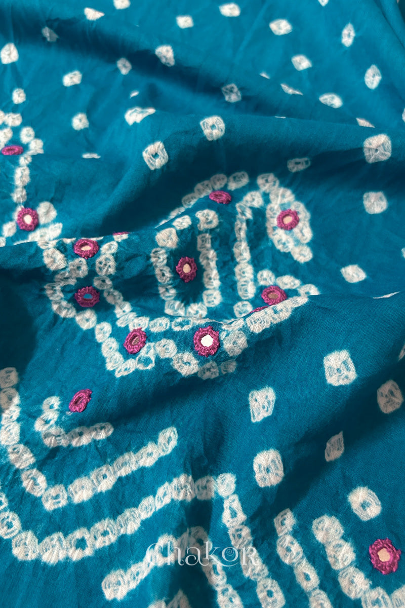 Detail of Kutch Bandhani Keri pattern with mirror embroidery on Turquoise cotton blouse fabric.
