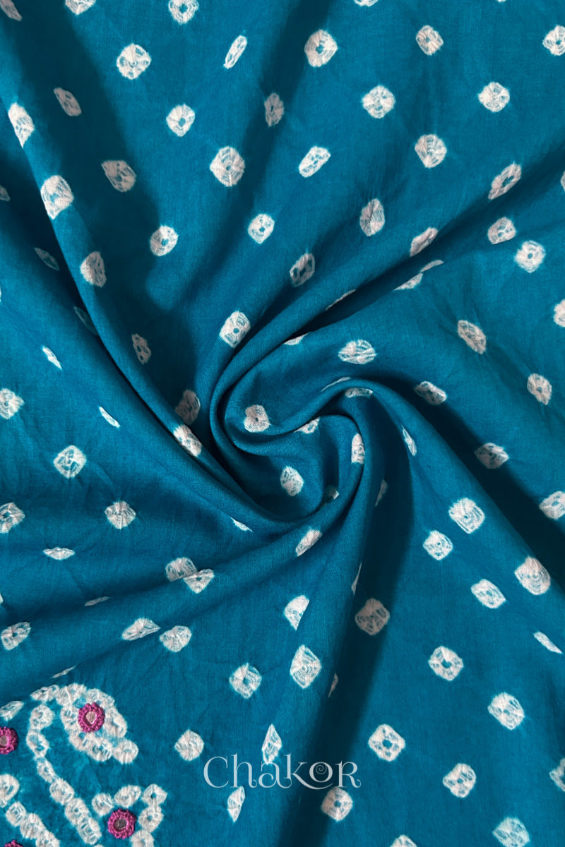 Turquoise Bandhani cotton blouse fabric showing fine tie-dye dots and its soft drape.
