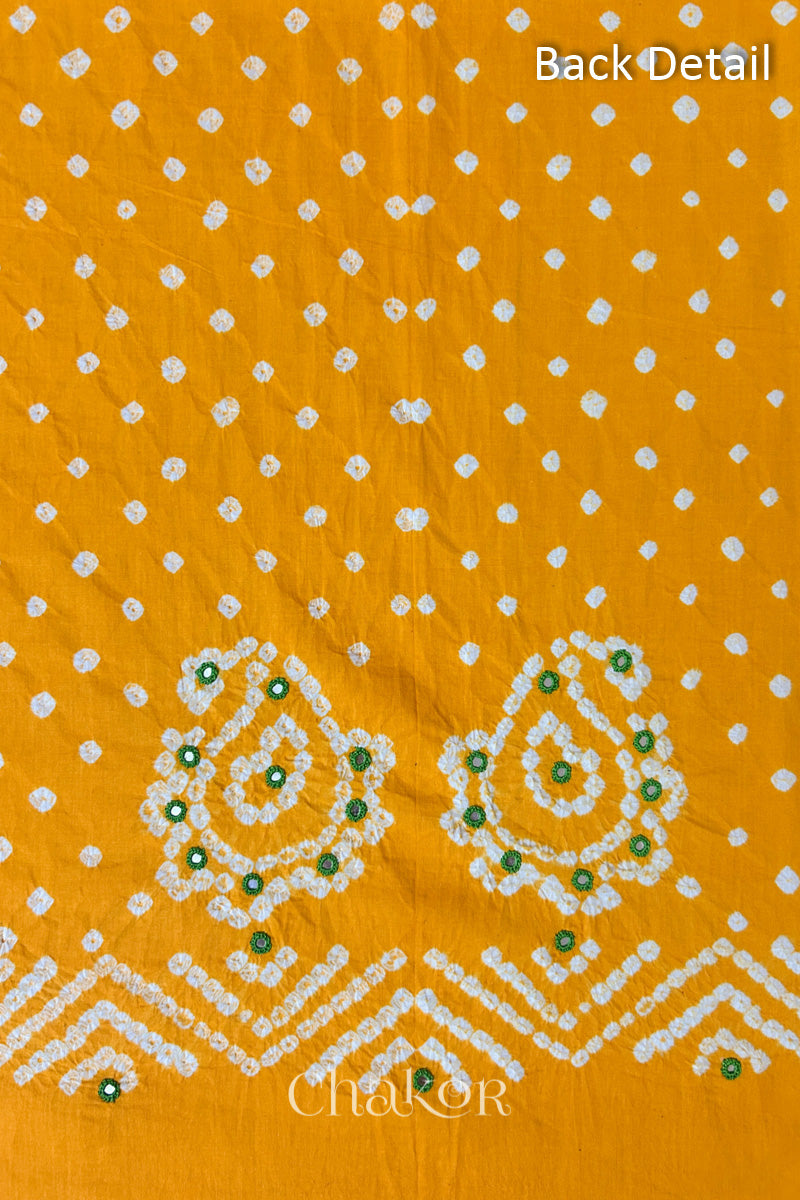 Close-up of yellow Kutch Bandhani fabric with white dotted pattern and Keri motifs for back.
