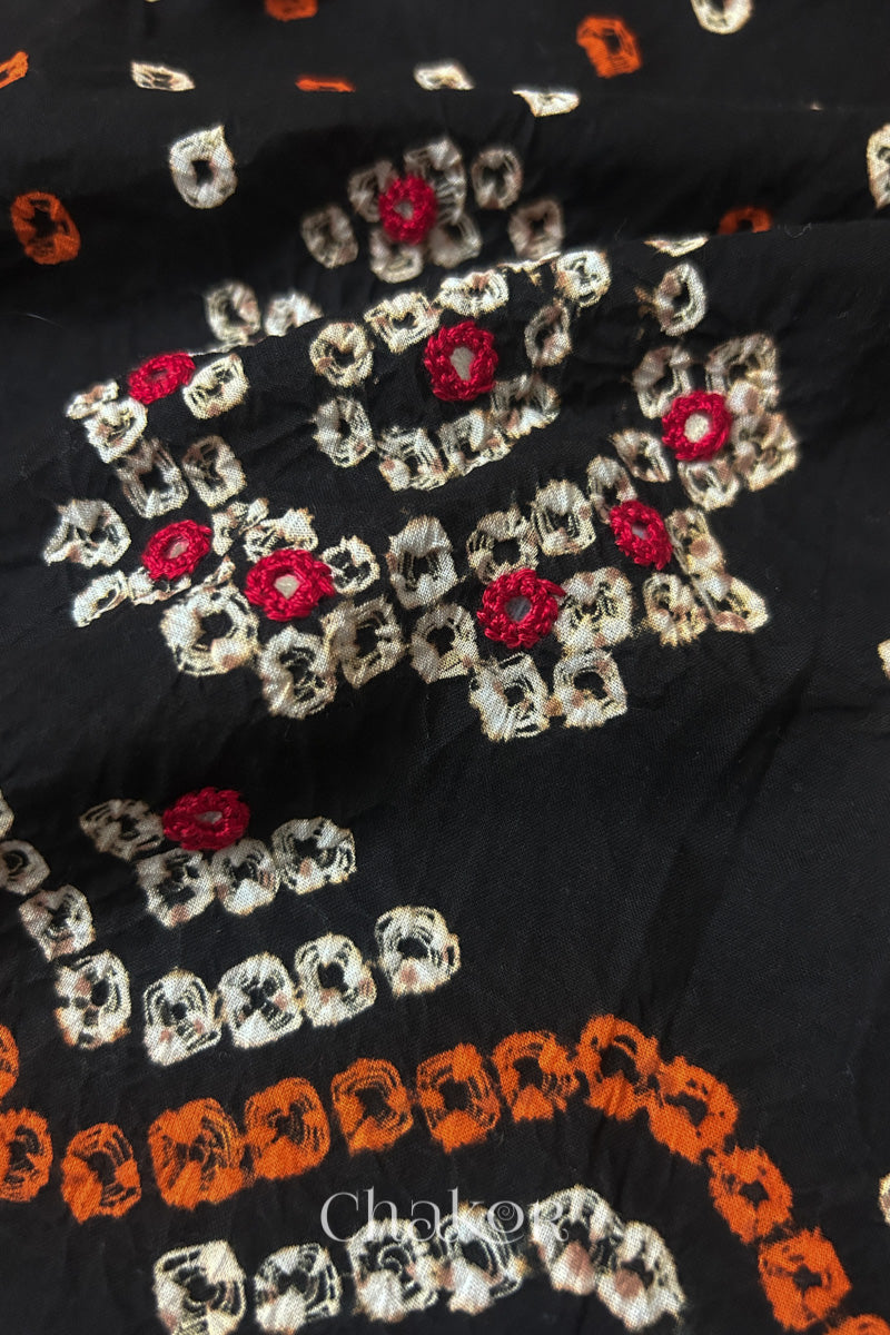 Detail of Kutch Bandhani Keri pattern with mirror embroidery on Black cotton blouse fabric.
