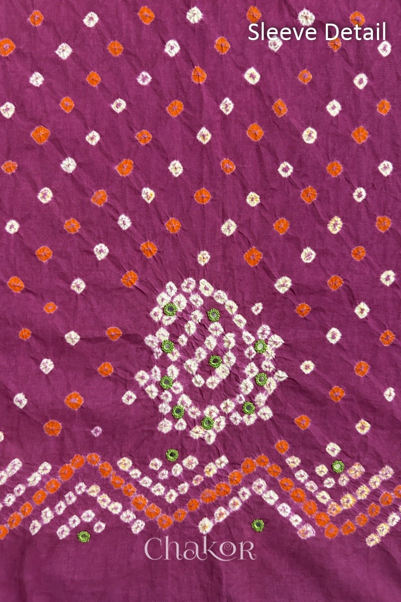 Magenta Kutch Bandhani cotton fabric with white tie-dye dots and Keri motif detail for sleeves.
