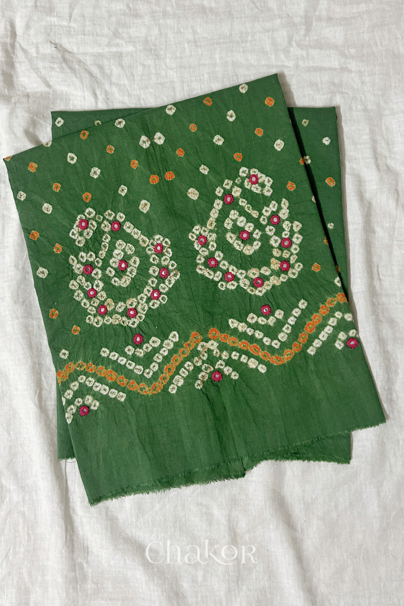 Mehendi Green Kutch Bandhani cotton unstitched blouse fabric with Keri pattern piece folded on white fabric.
