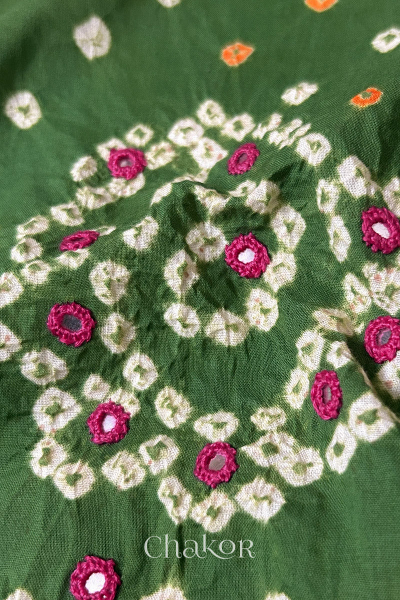 Detail of Kutch Bandhani Keri pattern with mirror embroidery on Mehendi Green cotton blouse fabric.
