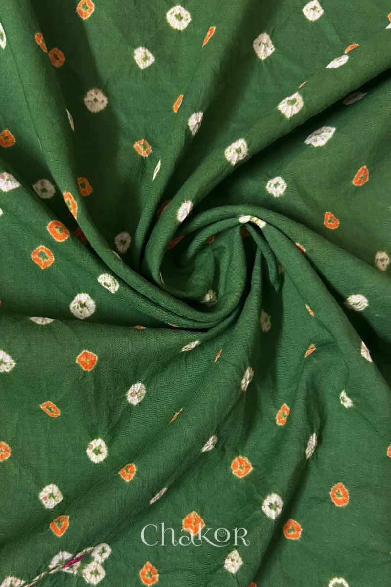 Mehendi Green Bandhani cotton blouse fabric showing fine tie-dye dots and its soft drape.
