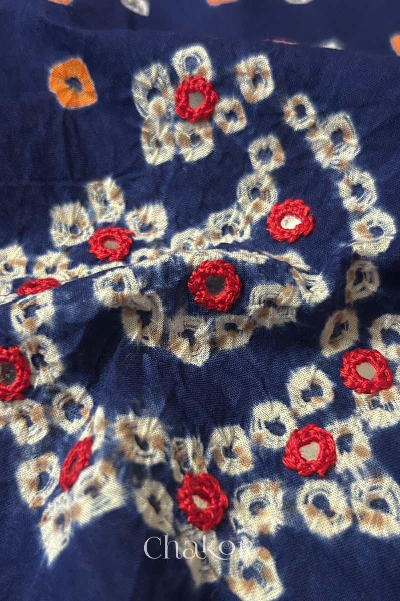Close-up of Navy Kutch Bandhani blouse fabric showing Keri motifs and hand-embroidered mirror work.
