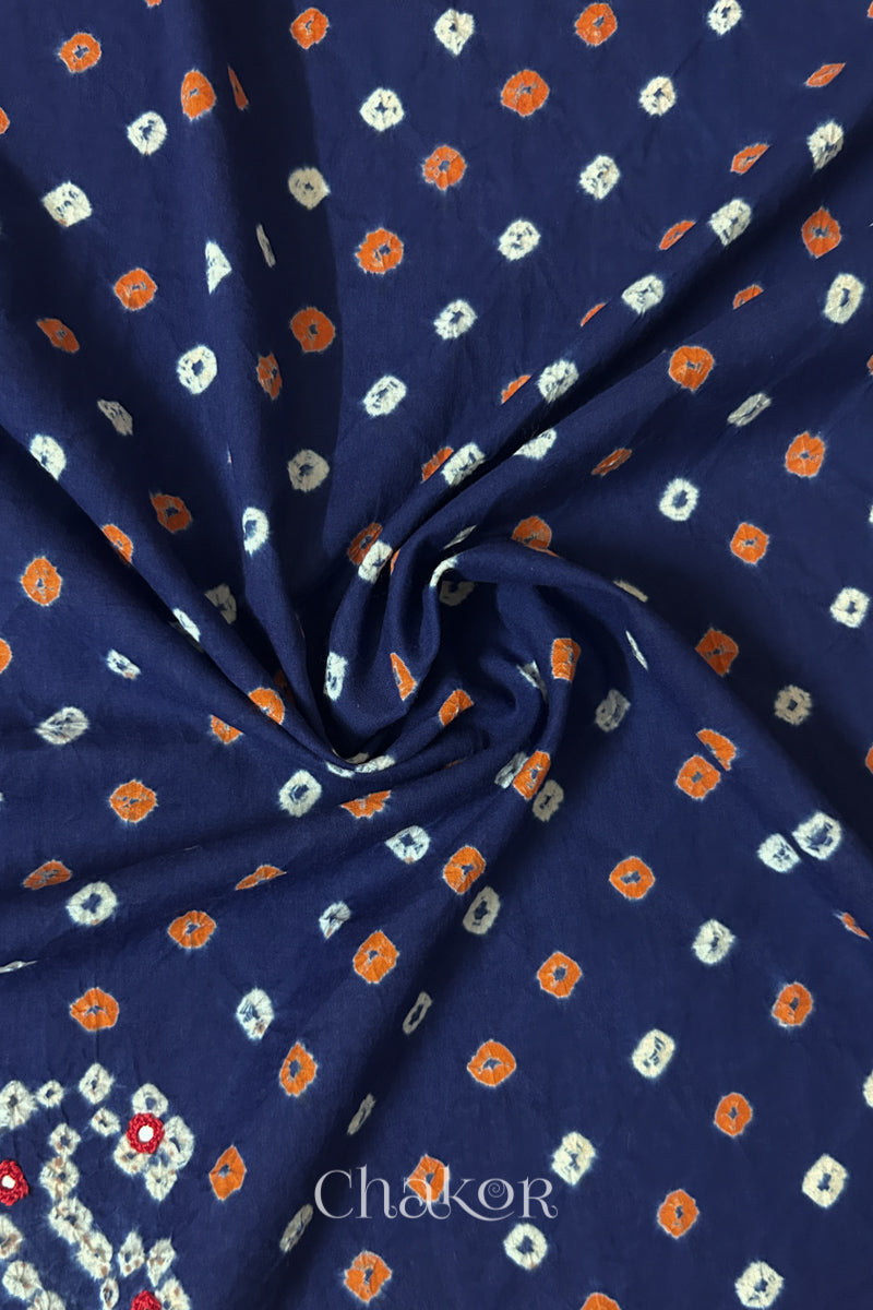 Navy Bandhani cotton blouse fabric showing fine tie-dye dots and its soft drape.
