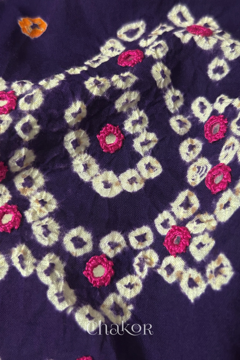 Detail of Kutch Bandhani Keri pattern with mirror embroidery on Purple cotton blouse fabric.
