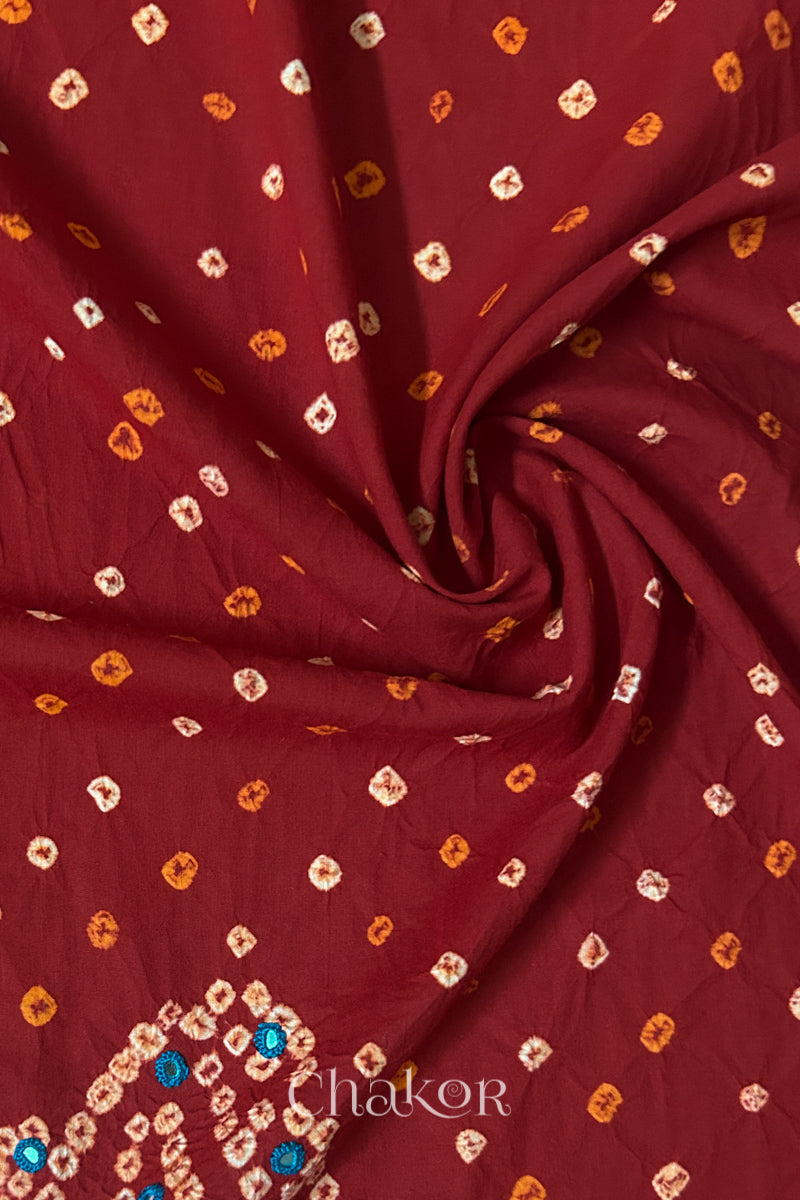 Red Bandhani cotton blouse fabric showing fine tie-dye dots and its soft drape.
