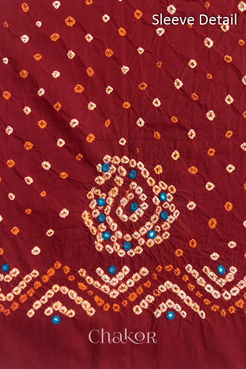 Red Kutch Bandhani cotton fabric with white tie-dye dots and Keri motif detail for sleeves.

