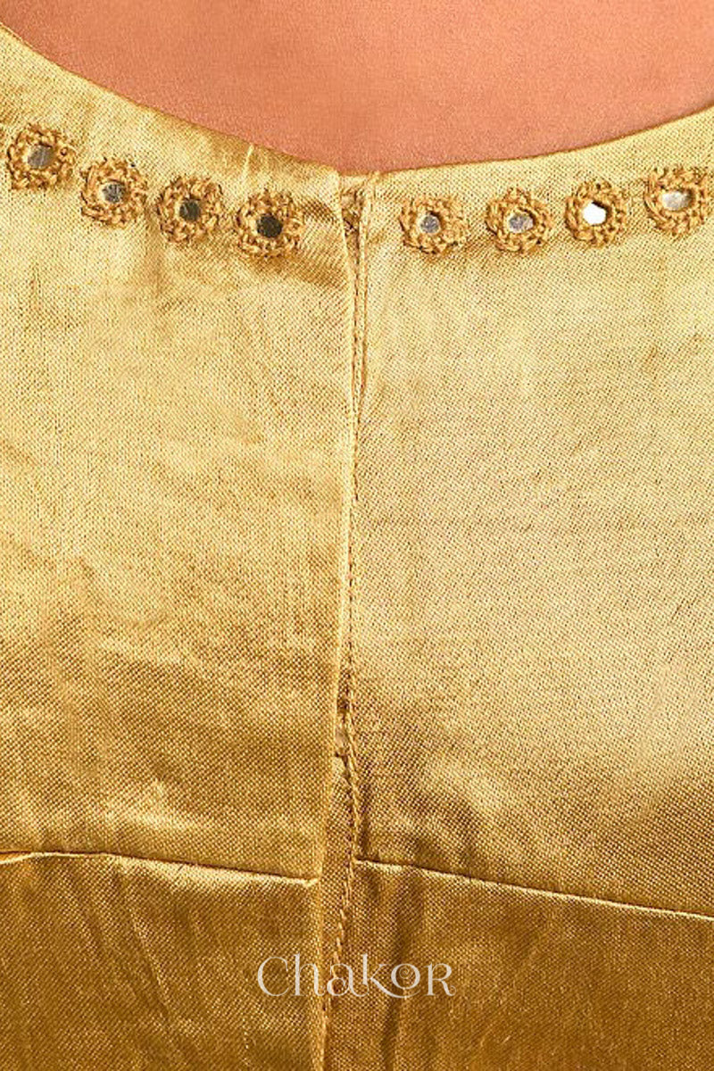 Woman wearing a handcrafted Beige Mashru Silk Blouse with intricate mirror embroidery.