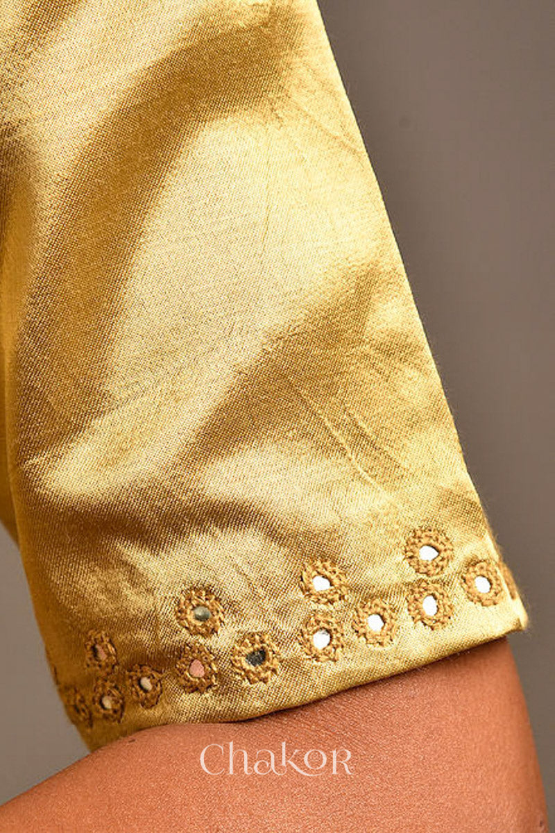 Woman wearing a handcrafted Beige Mashru Silk Blouse with intricate mirror embroidery.