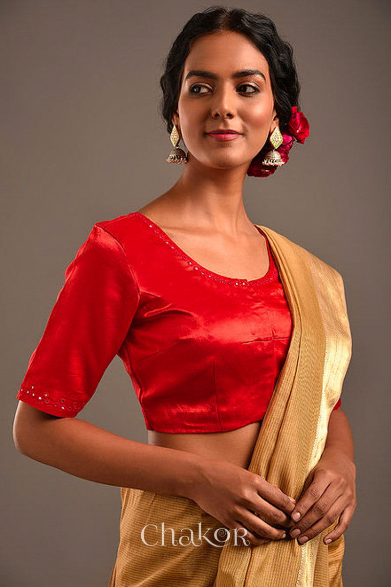Woman wearing a handcrafted Red Mashru Silk Blouse with intricate mirror embroidery.