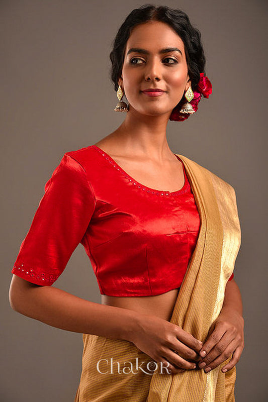 Woman wearing a handcrafted Red Mashru Silk Blouse with intricate mirror embroidery.