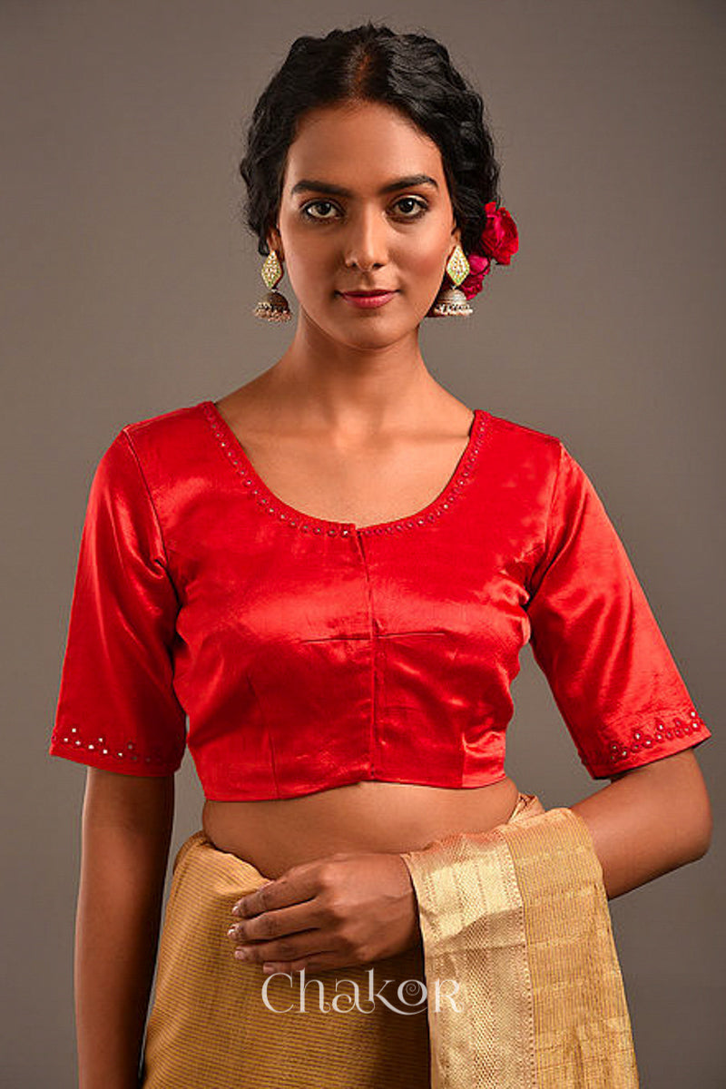 Woman wearing a handcrafted Red Mashru Silk Blouse with intricate mirror embroidery.