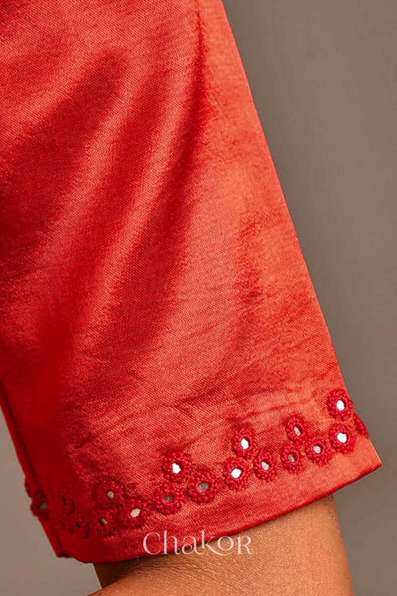 Woman wearing a handcrafted Red Mashru Silk Blouse with intricate mirror embroidery.