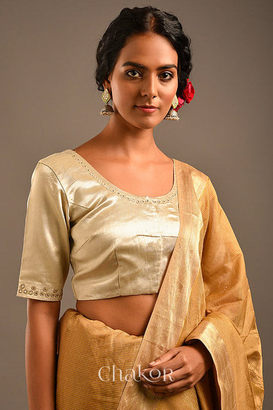 Woman wearing a handcrafted Silver Tan Mashru Silk Blouse with intricate mirror embroidery.