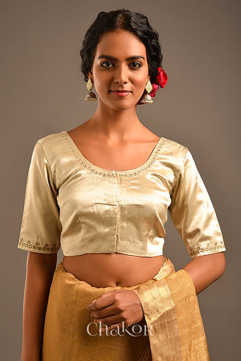 Woman wearing a handcrafted Silver Tan Mashru Silk Blouse with intricate mirror embroidery.