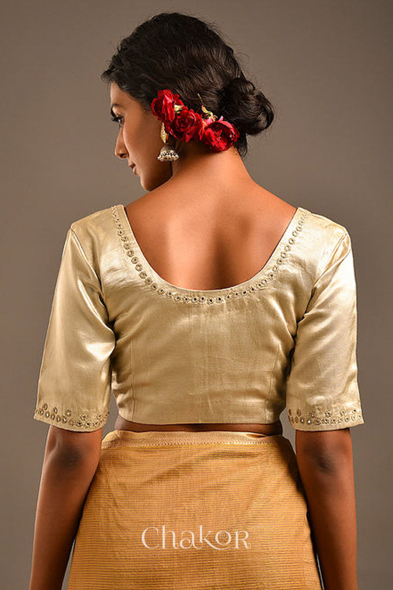 Woman wearing a handcrafted Silver Tan Mashru Silk Blouse with intricate mirror embroidery.