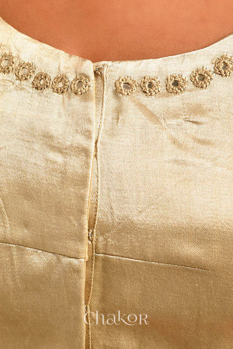 Woman wearing a handcrafted Silver Tan Mashru Silk Blouse with intricate mirror embroidery.