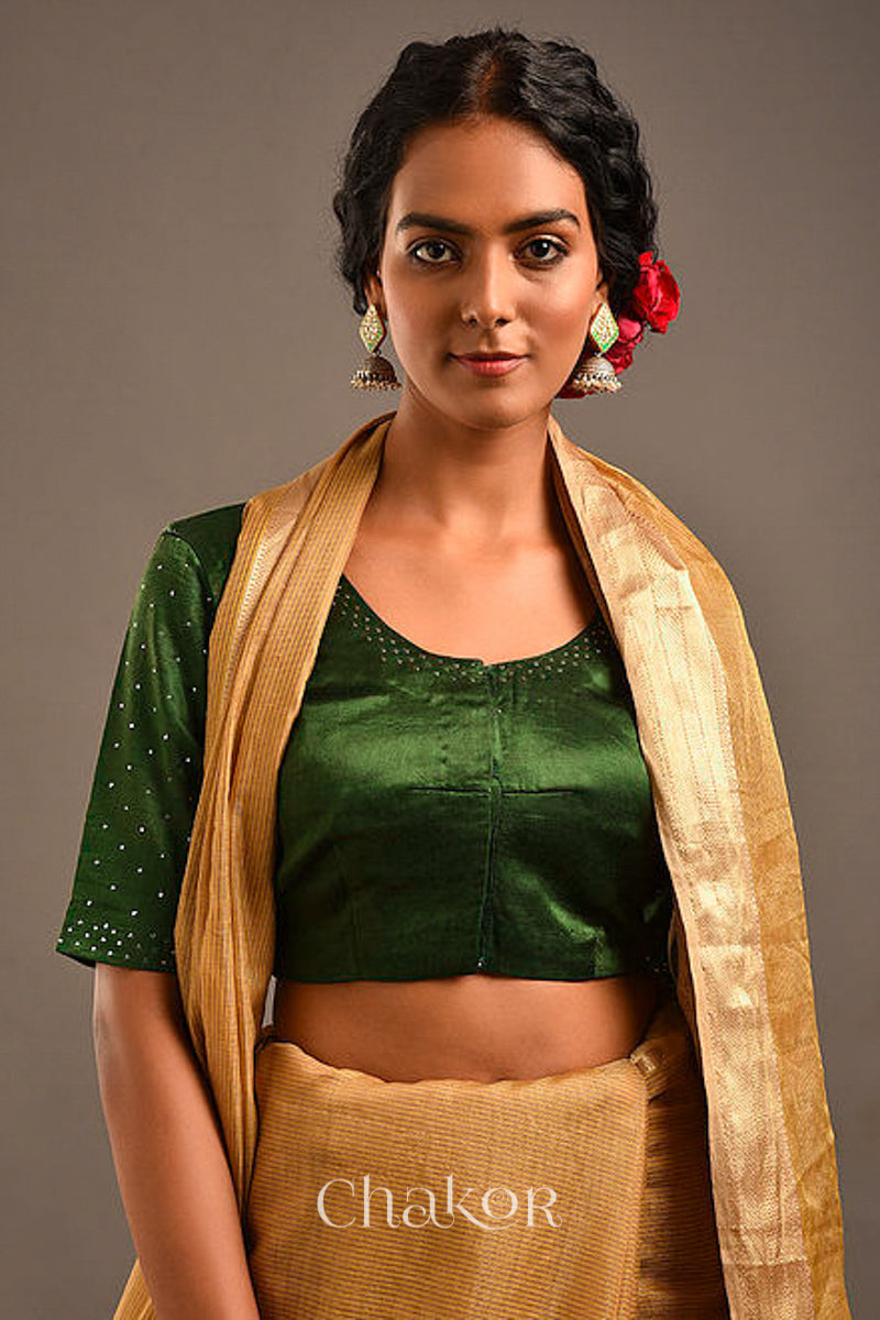 Woman wearing a handcrafted green Mashru Silk Blouse with mukaish embroidery.
