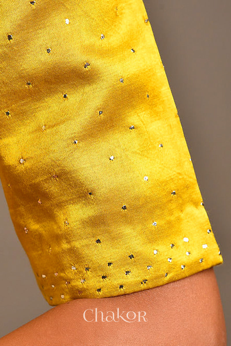 Woman wearing handcrafted Mustard Mashru Silk Blouse with mukaish embroidery.