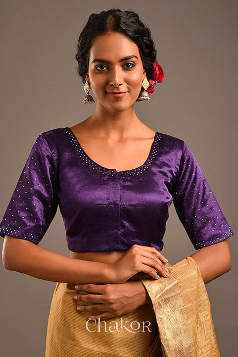 Woman wearing a handcrafted purple Mashru Silk Blouse with mukaish embroidery.