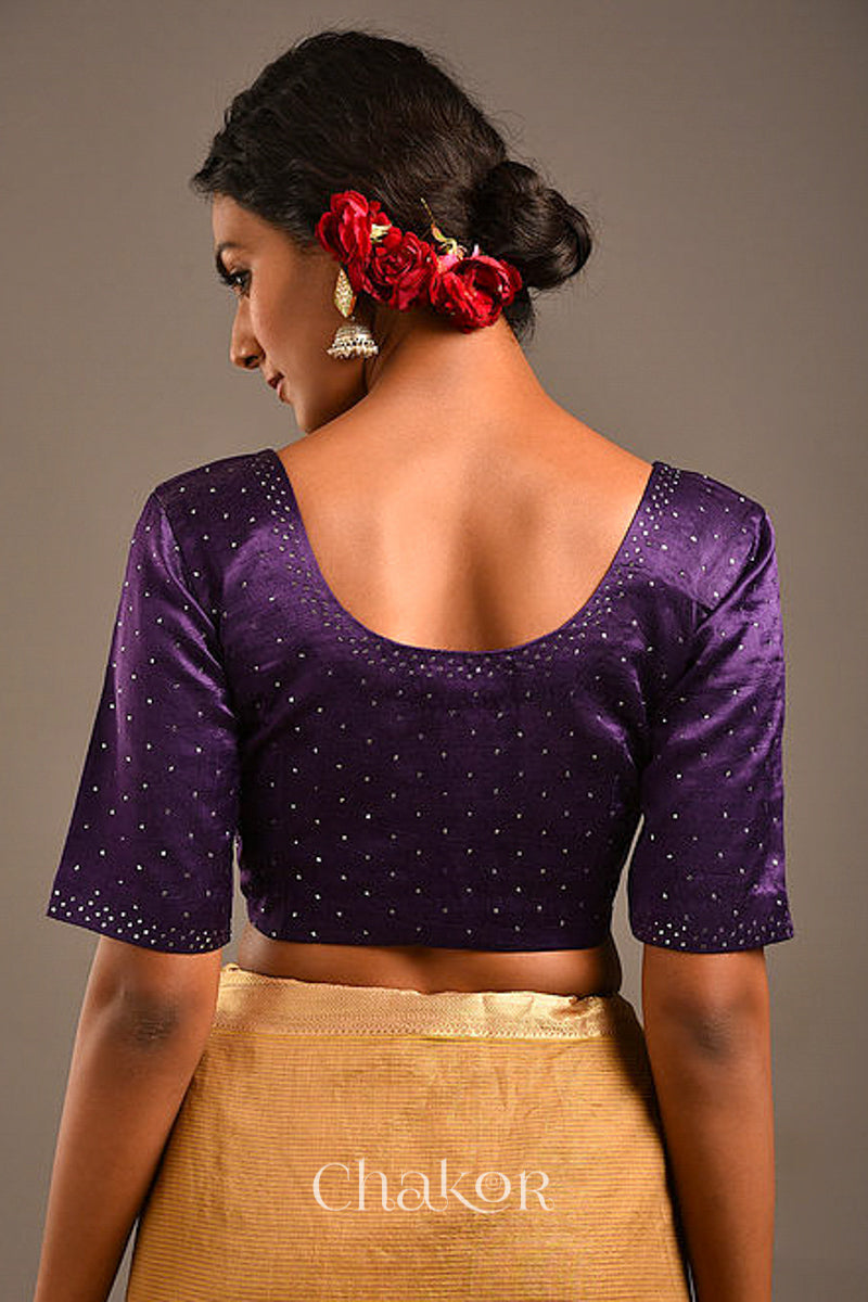 Woman wearing a handcrafted purple Mashru Silk Blouse with mukaish embroidery.
