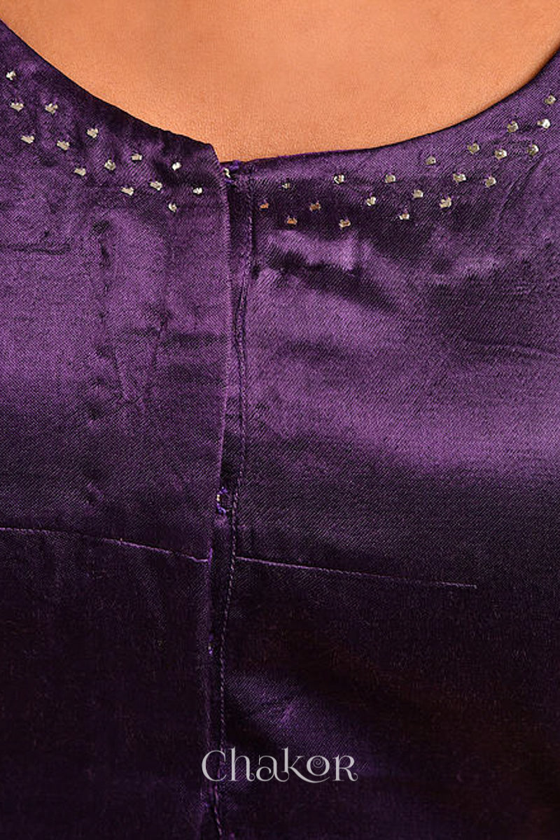 Woman wearing a handcrafted purple Mashru Silk Blouse with mukaish embroidery.