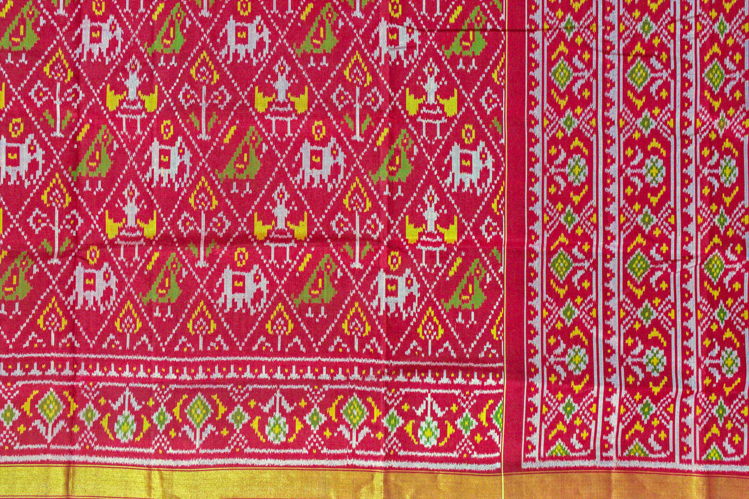 Traditional patterned saree in patola with red, green, and yellow colours.