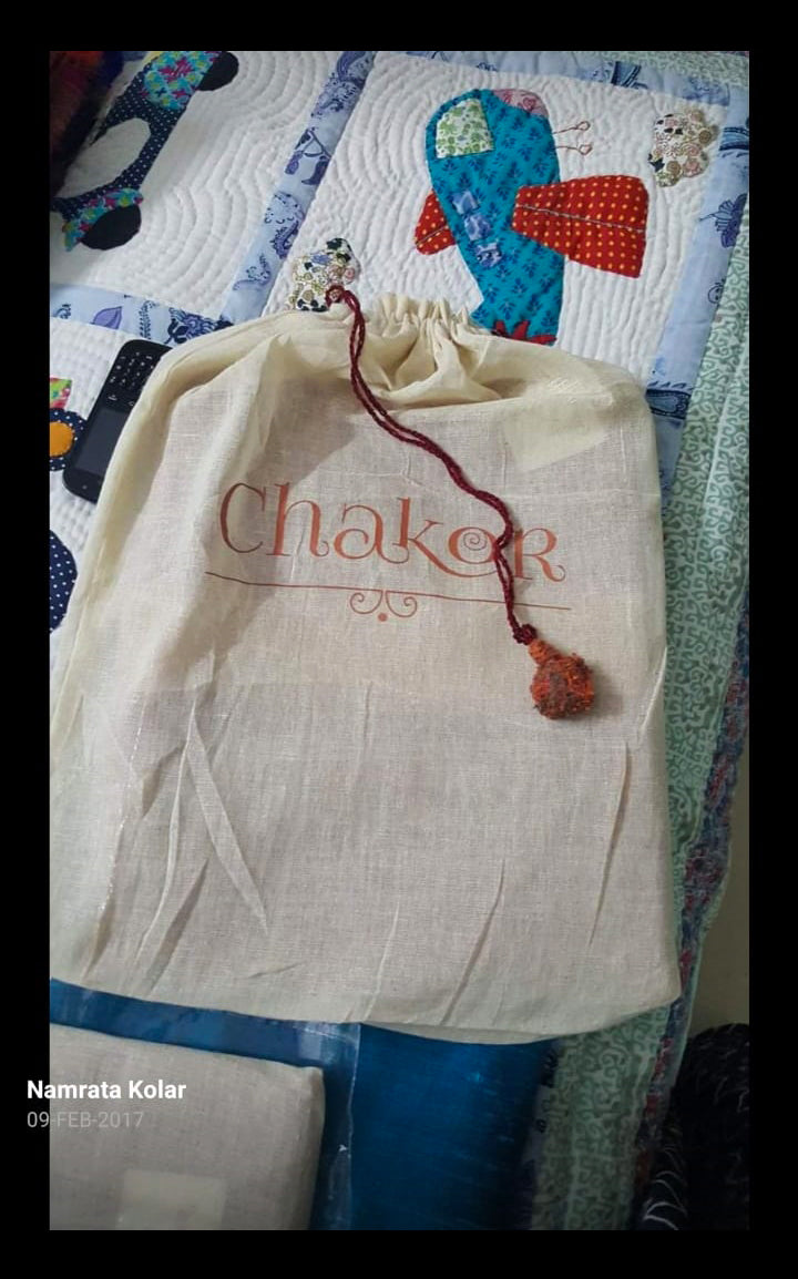 Drawstring bag with 'Chakor' branding on a colourful quilted background