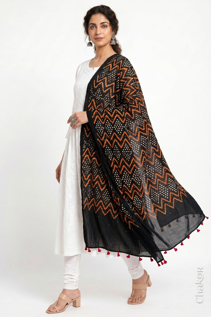 Black Kutch Bandhani dupatta with mukaish embroidery in mercerised mulmul cotton shown in side drape styling.
