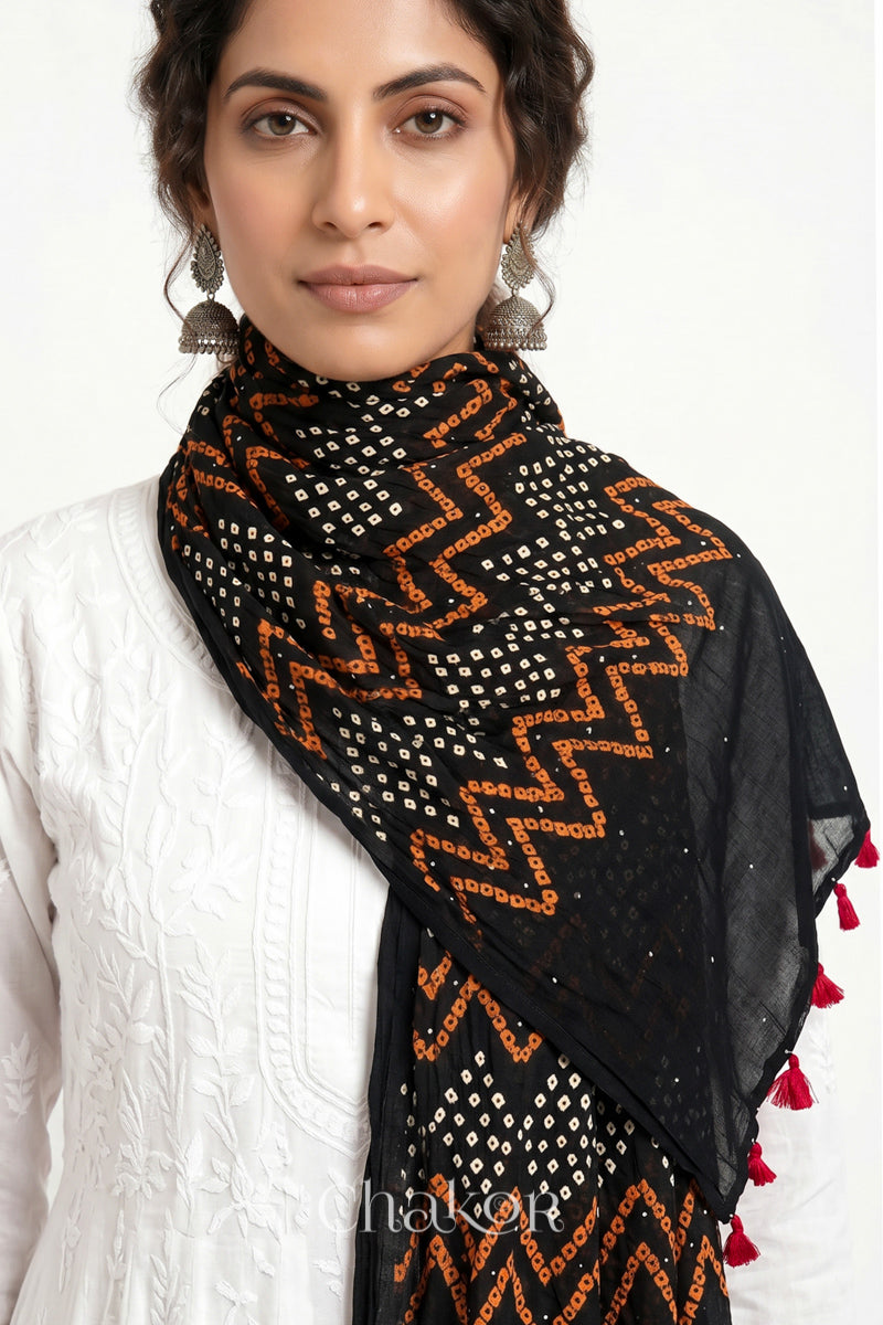 Black Kutch Bandhani dupatta with mukaish embroidery in lightweight mercerised mulmul cotton with flowing drape.
