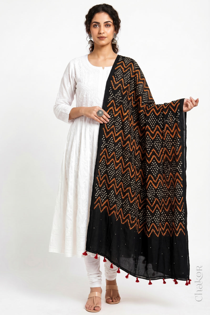 Black Kutch Bandhani dupatta with mukaish embroidery in lightweight mercerised mulmul cotton with flowing drape.
