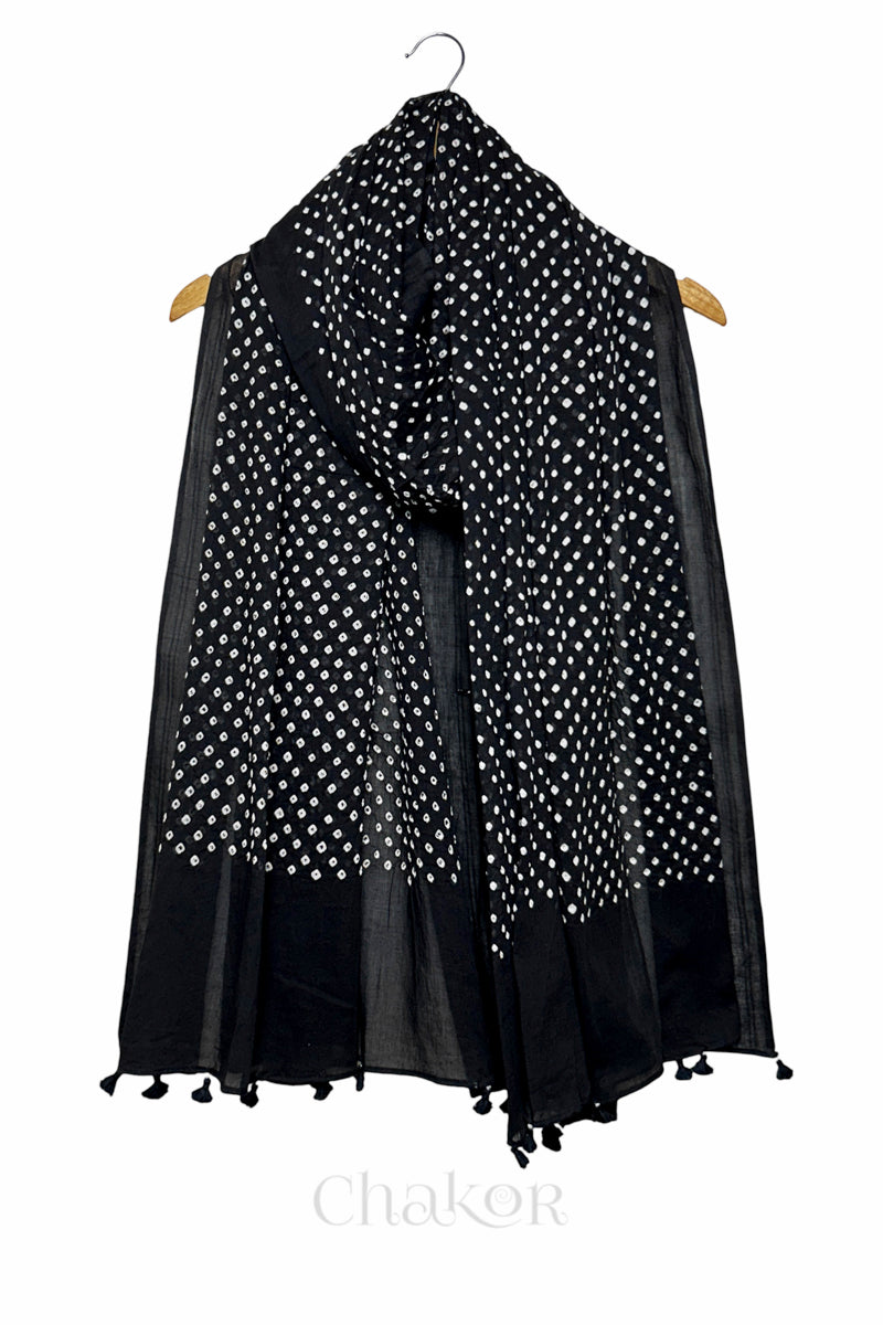 Black Bandhani mul cotton dupatta draped on hanger showing tie-dye dot pattern and tasselled edge.