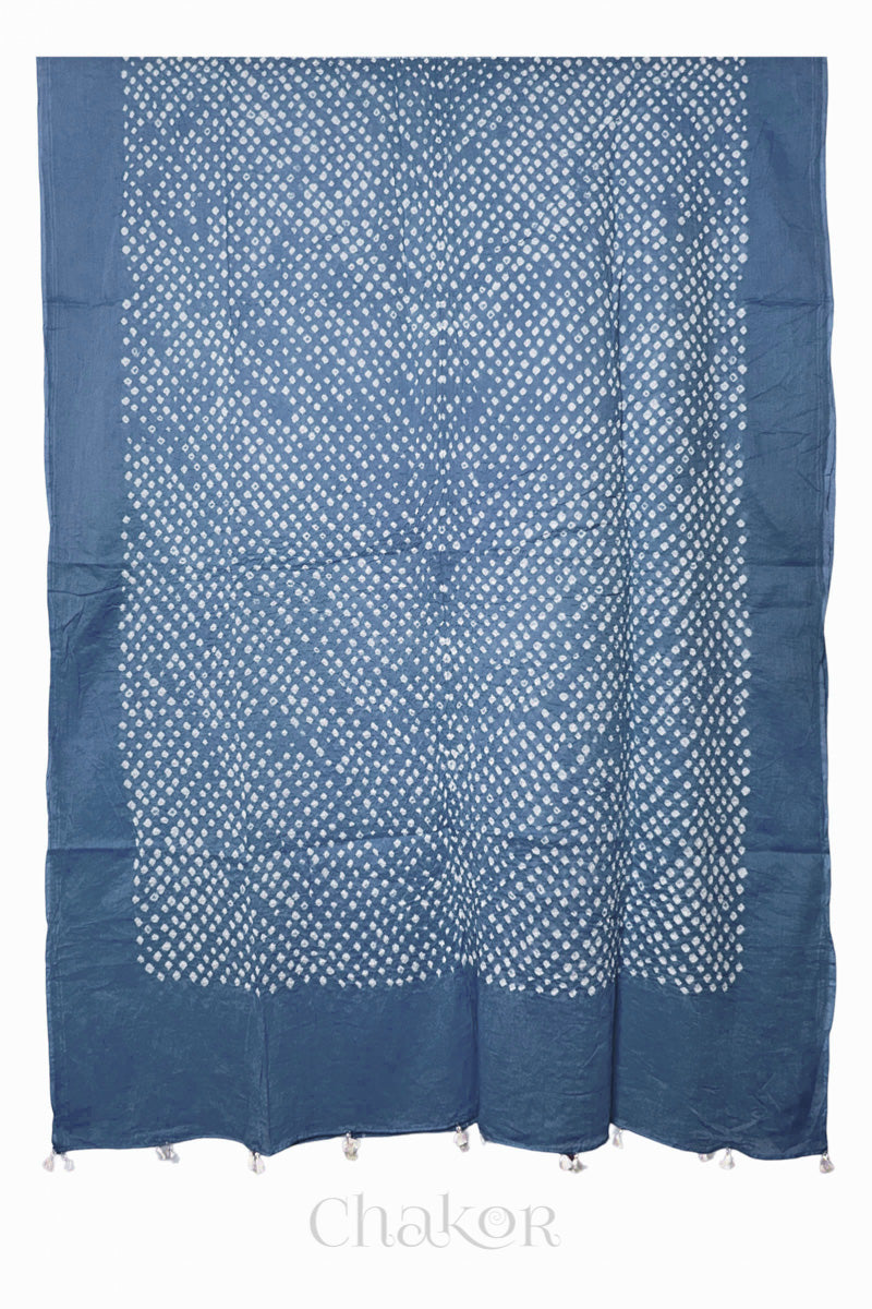 Chakor's blue grey cotton mul mul dupatta with white bandhani pattern, edged with tassels at the end.
