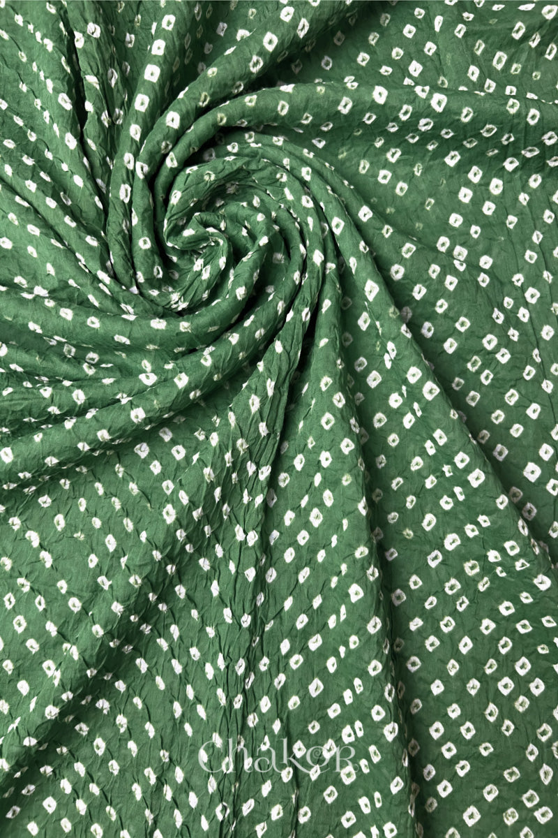 Detail view of Moss green Bandhani mul cotton dupatta highlighting tie-dye dots arranged in spiral drape.