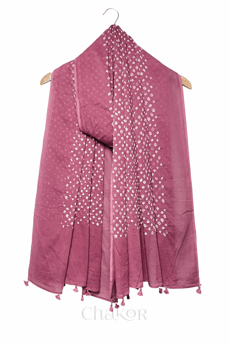 Old rose Bandhani mul cotton dupatta draped on hanger showing tie-dye dot pattern and tasselled edge.
