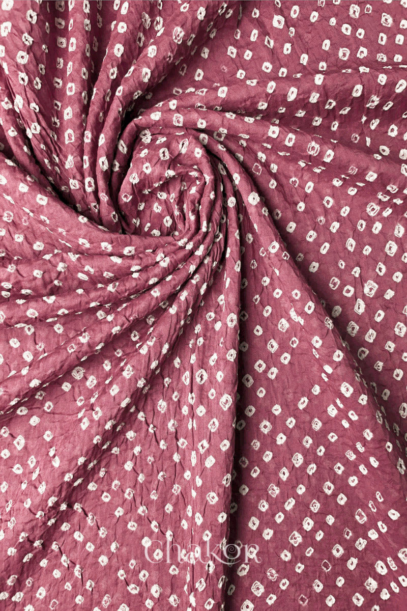 Detail view of Old rose Bandhani mul cotton dupatta highlighting tie-dye dots arranged in spiral drape.