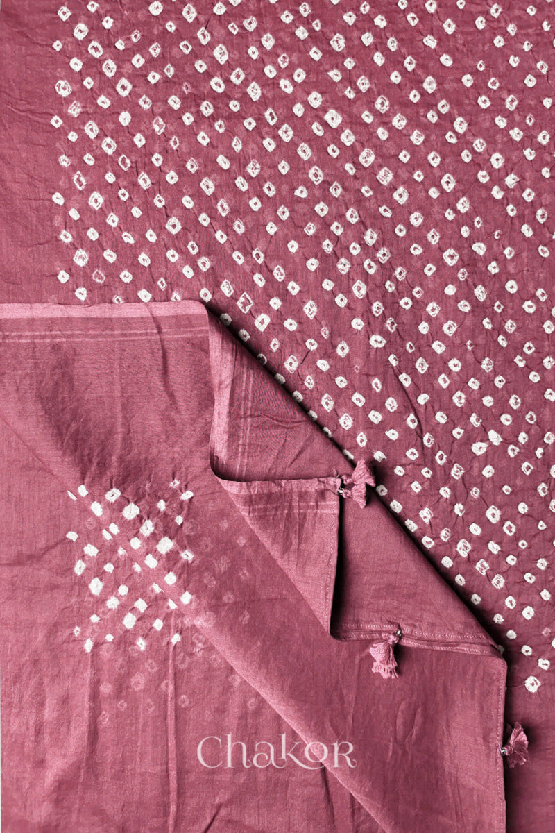 Corner detail of Old rose Bandhani mul cotton dupatta showing pallu tasseled edge and tie-dye motifs.