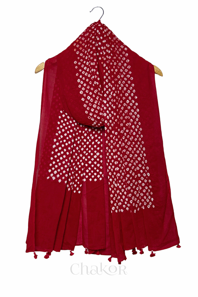Tomato Red Bandhani mul cotton dupatta draped on hanger showing tie-dye dot pattern and tasselled edge.