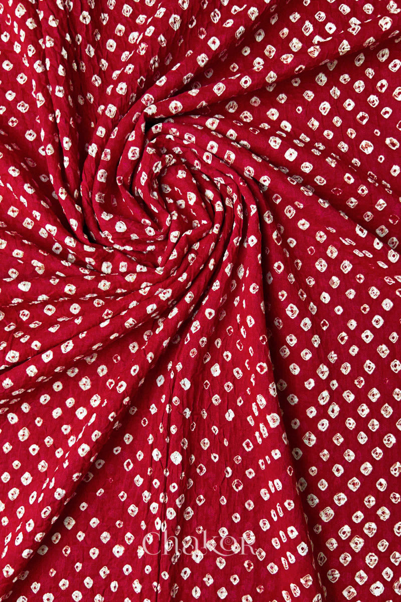 Twisted detail view of Tomato Red Bandhani mul cotton dupatta highlighting tie-dye dots.