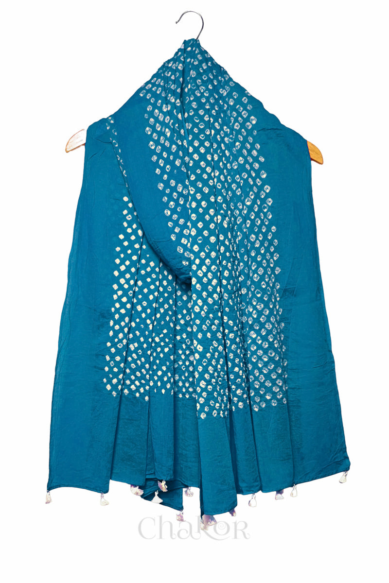 Turquoise Bandhani mul cotton dupatta draped on hanger showing tie-dye dot pattern and tasselled edge.