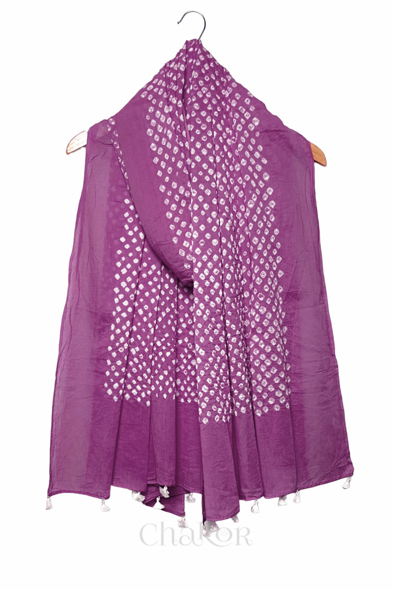 Violet purple Bandhani mul cotton dupatta draped on hanger showing tie-dye dot pattern and tasselled edge.
