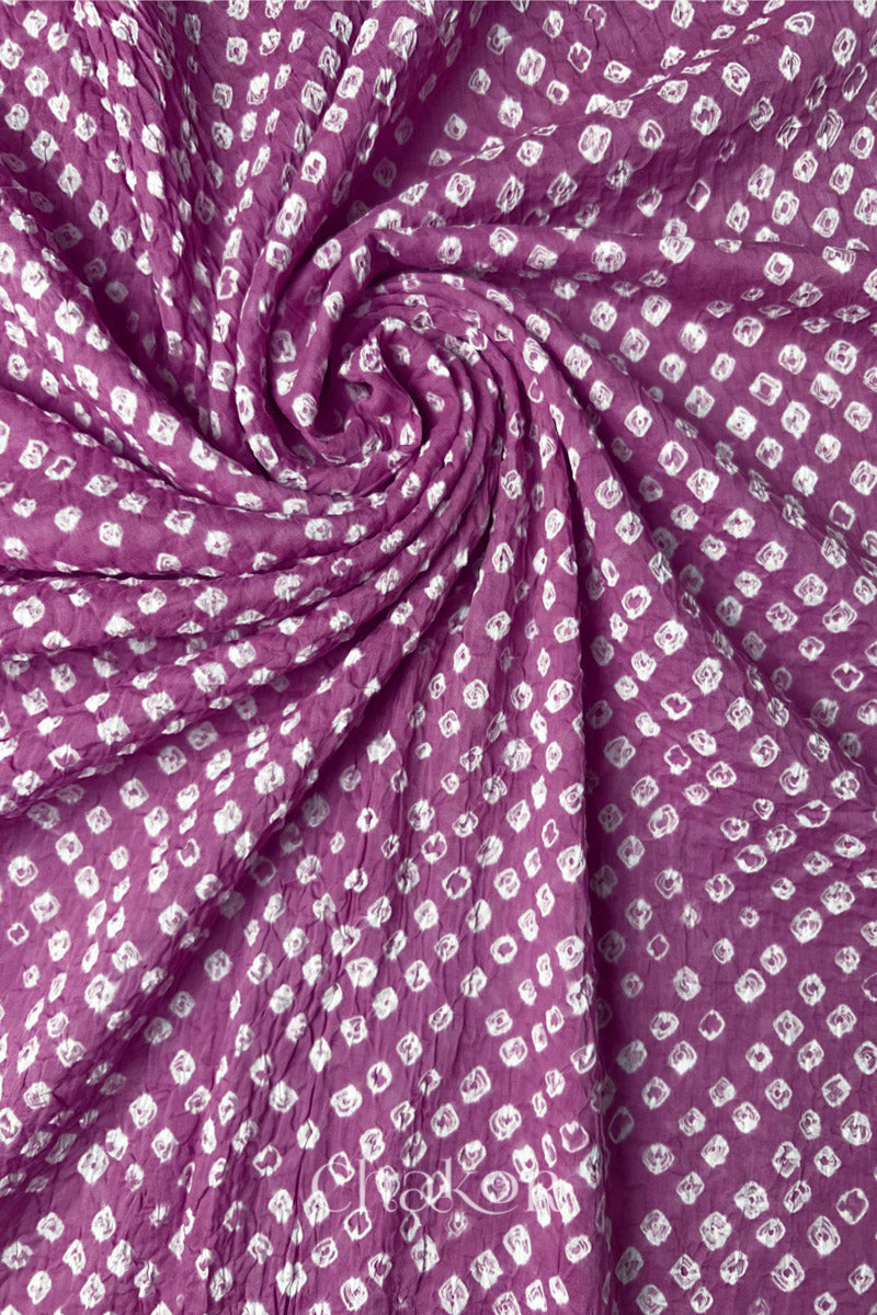 Detail view of Violet purple Bandhani mul cotton dupatta highlighting tie-dye dots arranged in spiral drape.