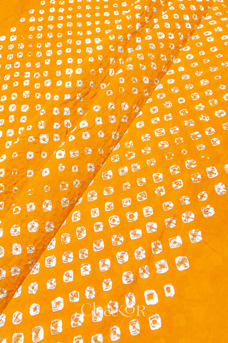 Close-up of Yellow Bandhani tie-dye dot pattern on mul cotton dupatta.