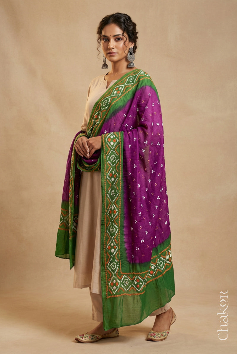 Model wearing magenta and green Bandhani mul cotton dupatta with tie-dye dot pattern draped over a beige kurta.