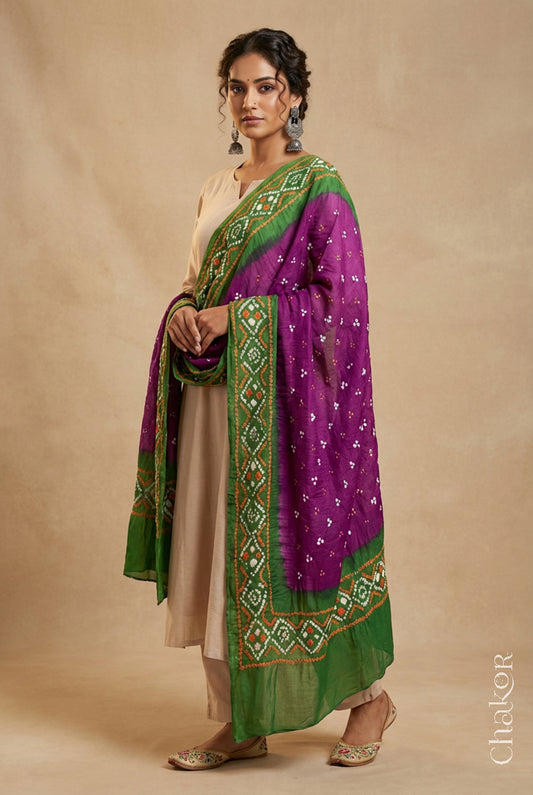 Model wearing magenta and green Bandhani mul cotton dupatta with tie-dye dot pattern draped over a beige kurta.