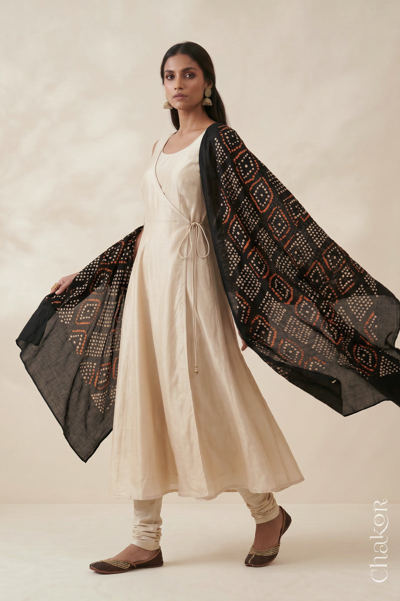 Black handmade Bandhani mulmul cotton dupatta shown in flowing drape.
