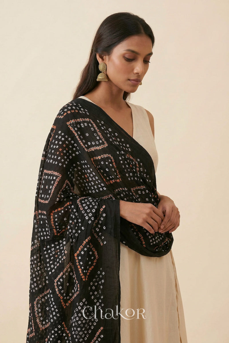 Black Kutch Bandhani dupatta styled around the neck in soft mercerised mulmul cotton.
