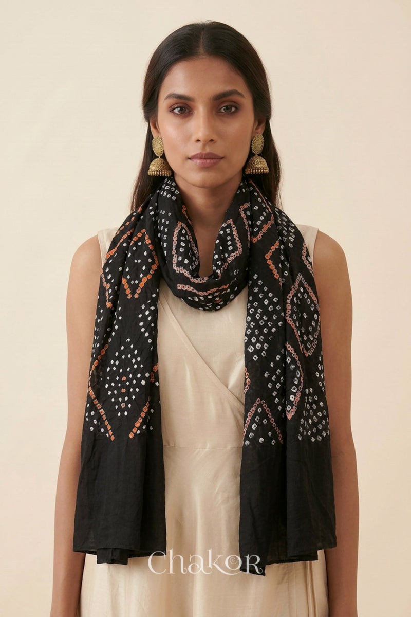 Black Kutch Bandhani dupatta styled around the neck in soft mercerised mulmul cotton.
